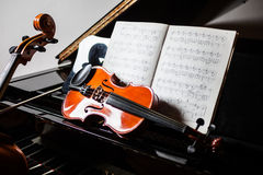 Violin resting on grand piano